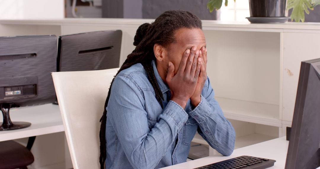 Stressed Employee in Office by Computer Screen