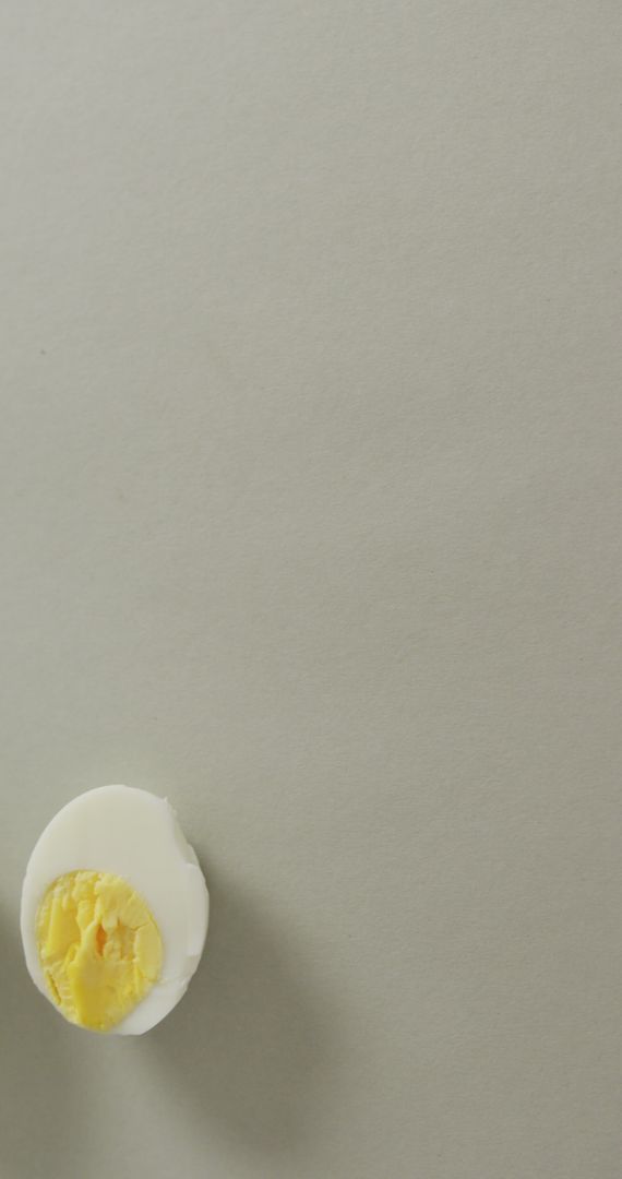 Minimalist Hard Boiled Egg Halves on Grey Background