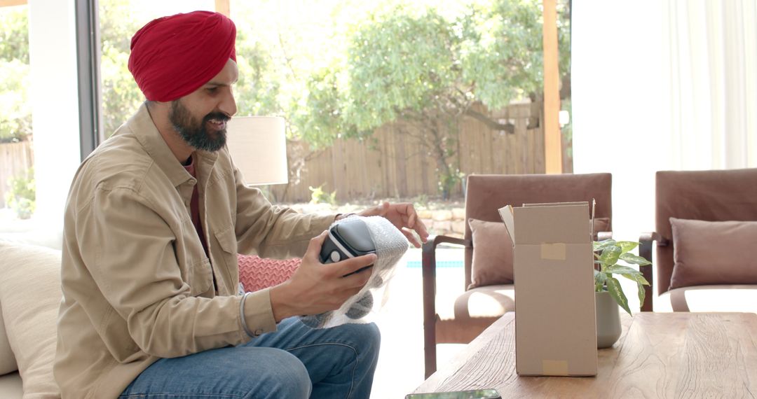 Man Unboxing New Electronic Device with Joy in Living Room