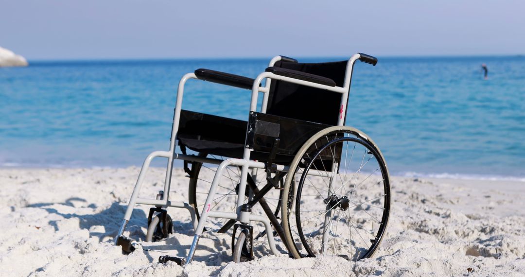 Empty Wheelchair on Sandy Beach by Ocean - Free Images, Stock Photos and Pictures on Pikwizard.com