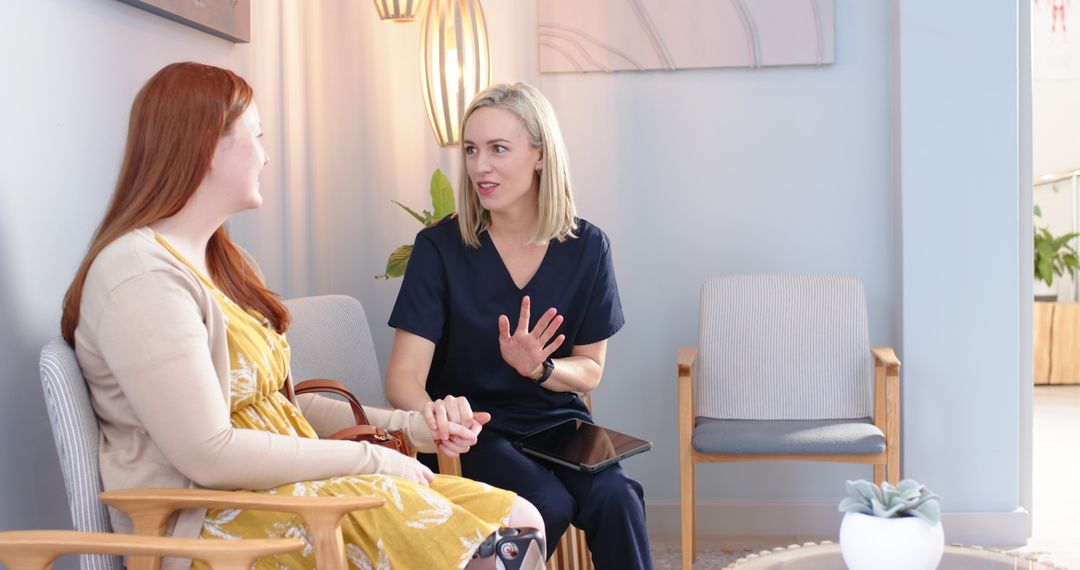 Healthcare Professional Conversing with Patient in Modern Waiting Area