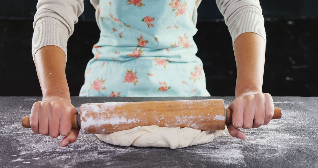 Close-up of woman rolling dough with rolling pin on floured surface - Free Images, Stock Photos and Pictures on Pikwizard.com