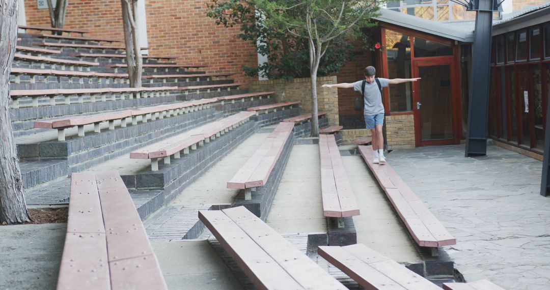 Young Boy Balancing on Campus Amphitheater Bench