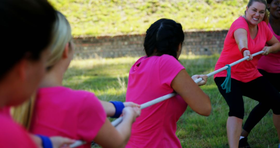 Women Competing in Tug of War Outdoors, Wearing Pink T-Shirts - Free Images, Stock Photos and Pictures on Pikwizard.com