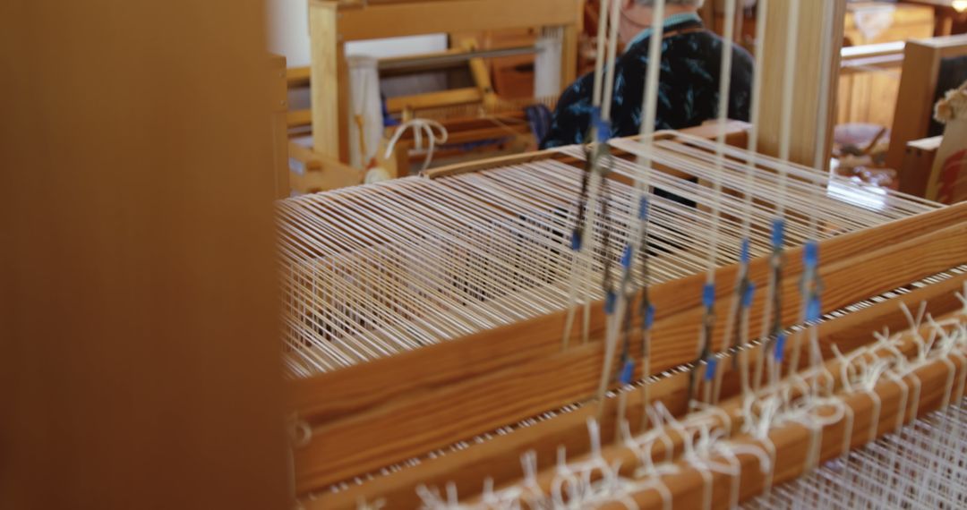 Senior Woman Operating Handloom Machine in Artisan Workshop