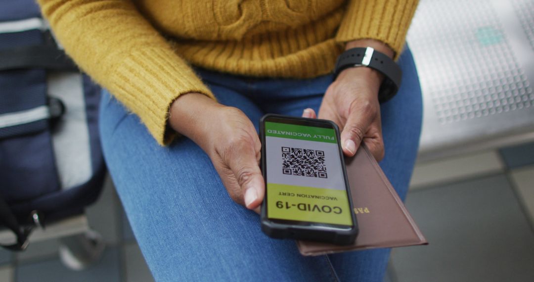 Traveler with Smartphone Checking COVID-19 Vaccination Certificate