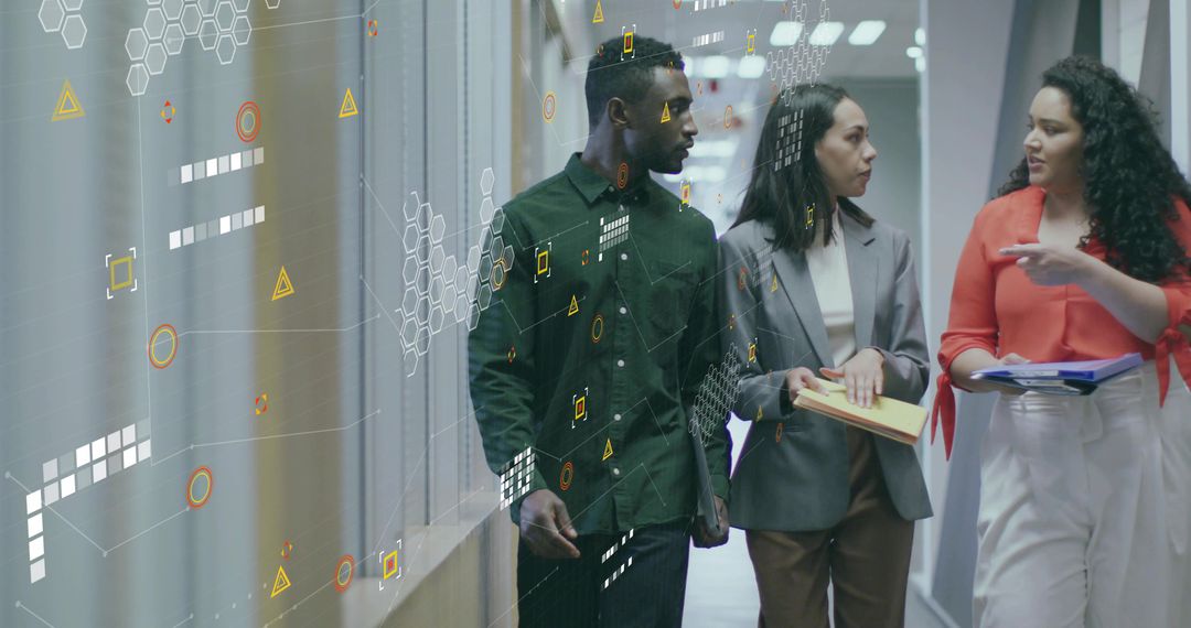 Business Team Analyzing Data While Walking in Office Hallway