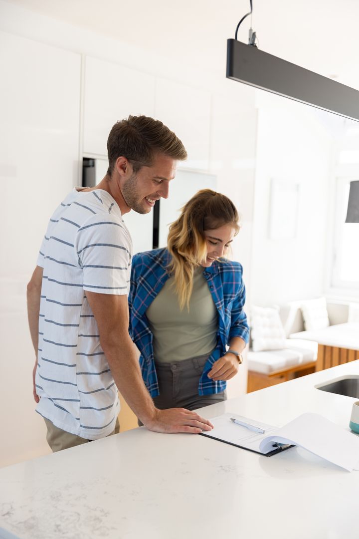 Couple Discussing Plans at Kitchen Island in Modern Home