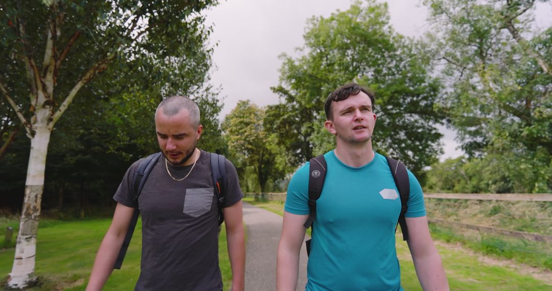 Two Friends Hiking in Park Enjoying Nature and Conversation