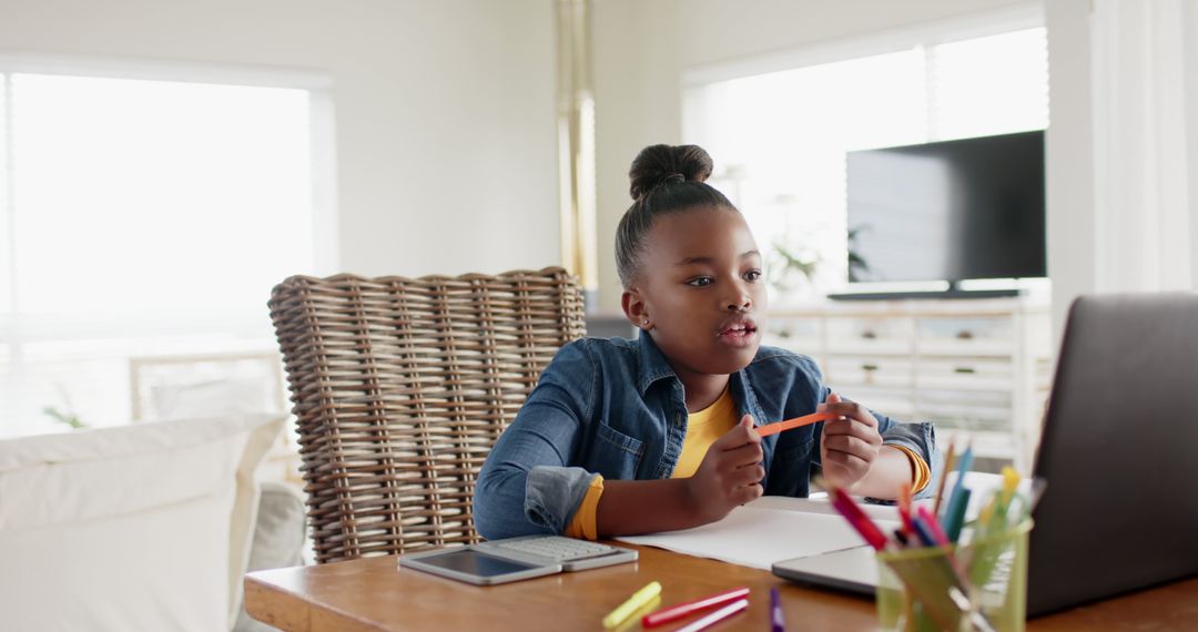 Young Girl Learning Online at Home