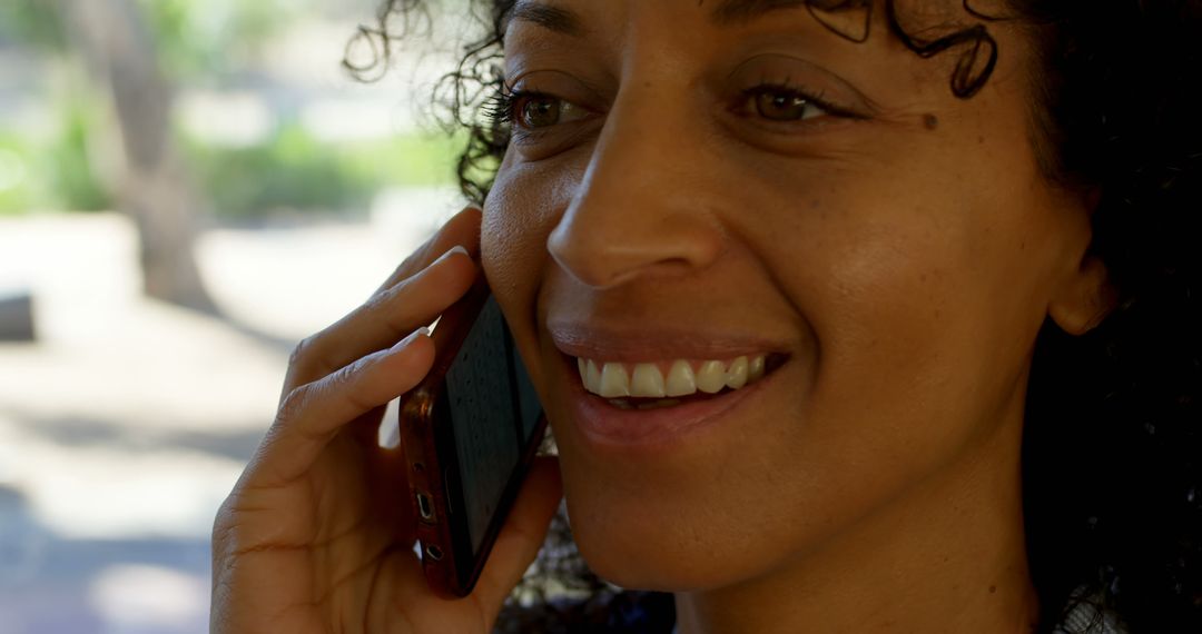 Smiling Woman Talking on Smartphone Outdoors - Free Images, Stock Photos and Pictures on Pikwizard.com