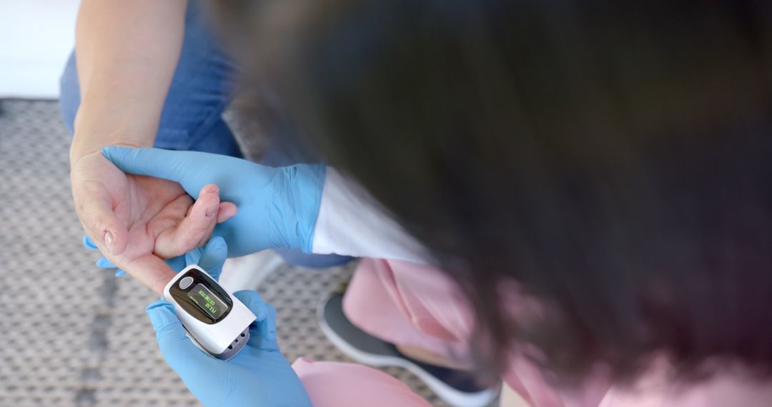 Healthcare Worker Checks Oxygen Levels with Pulse Oximeter