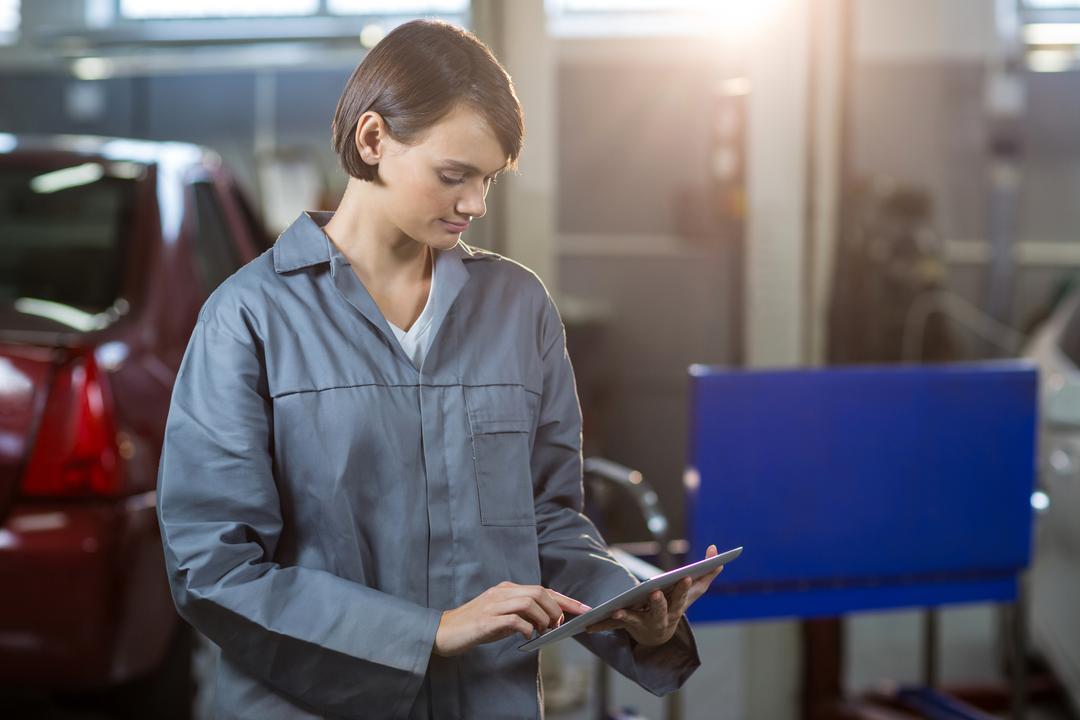 Female Mechanic Using Digital Tablet in Repair Garage - Free Images, Stock Photos and Pictures on Pikwizard.com