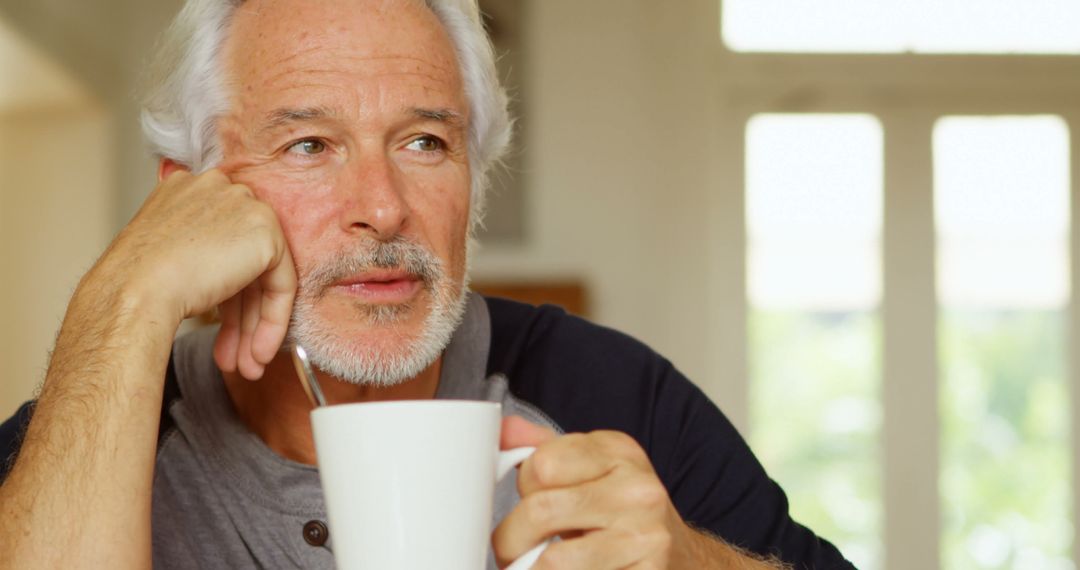 Senior Man Drinking Coffee and Reflecting Indoors at Home - Free Images, Stock Photos and Pictures on Pikwizard.com