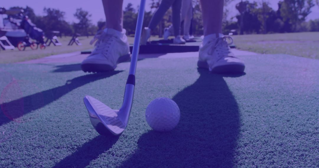 Caucasian Man Playing Golf with Club and Ball on Course