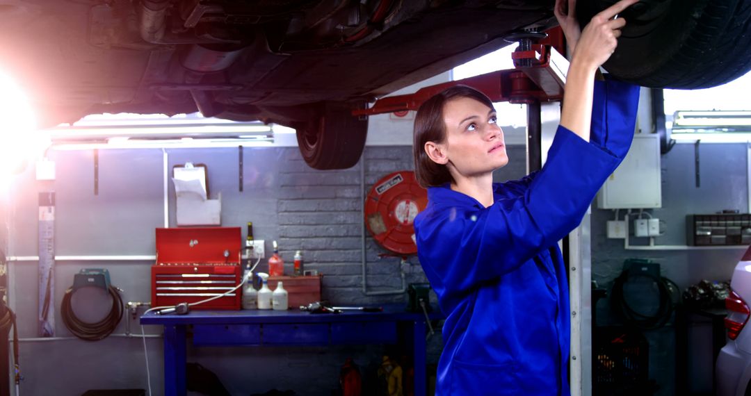 Female mechanic servicing a car in garage 4k - Free Images, Stock Photos and Pictures on Pikwizard.com