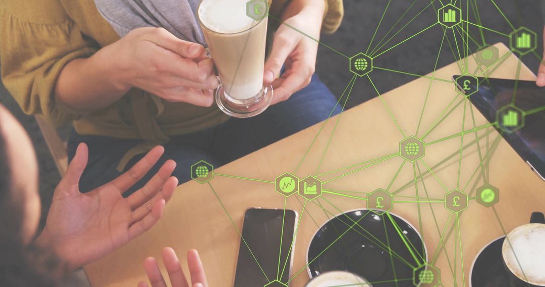 Team discussing coffee and devices with green digital network overlay for collaboration