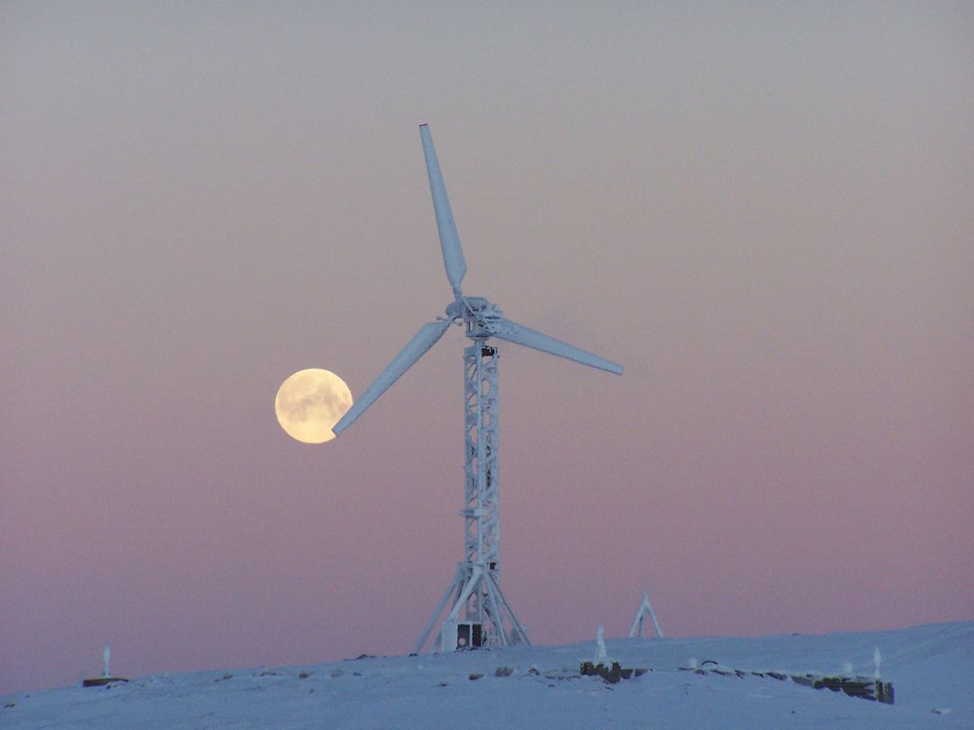 Full Moon and Wind Turbine on Snowy Landscape During Sunset - Free Images, Stock Photos and Pictures on Pikwizard.com