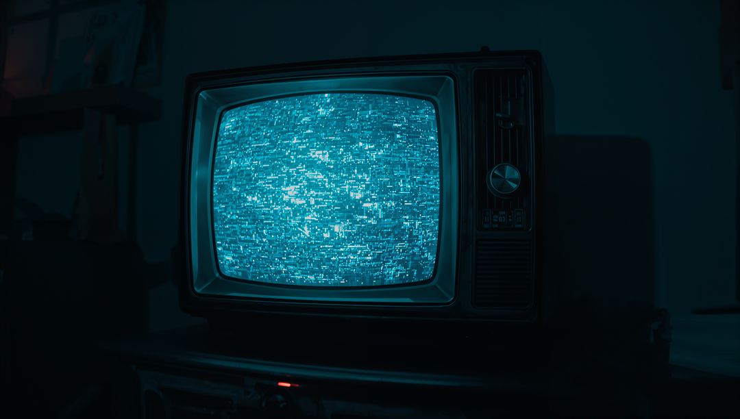 Retro TV Showing Static in Dimly Lit Room