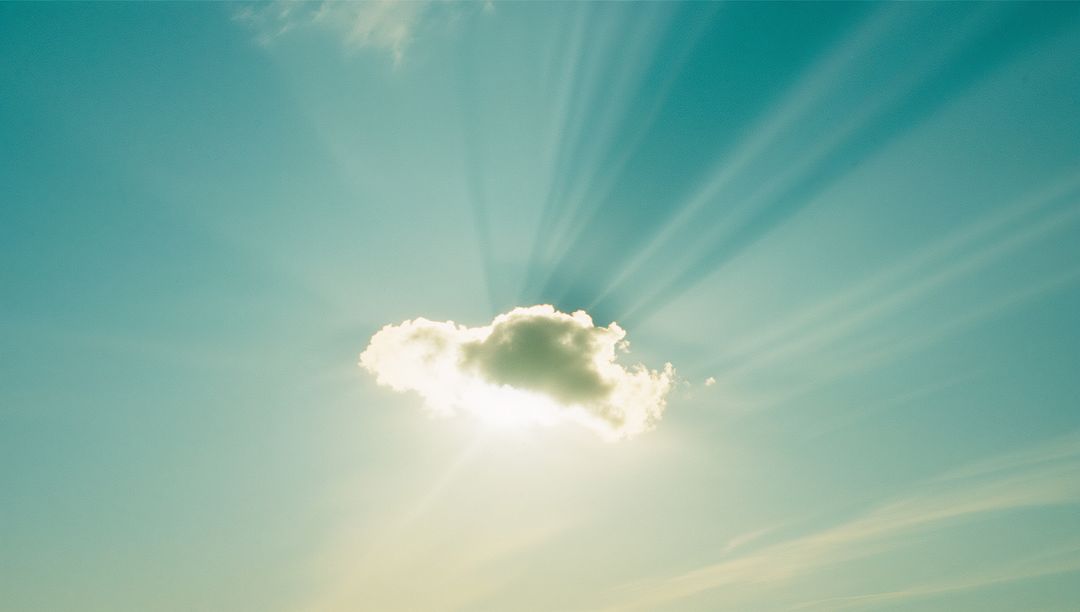 Sunbeams Radiating Behind Single Cumulus Cloud