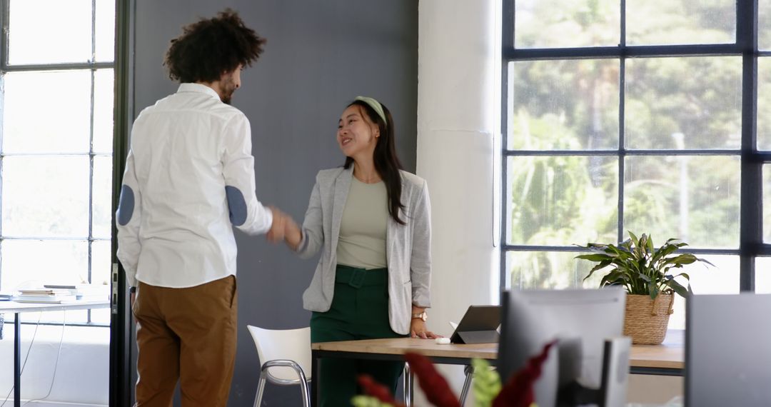 Business Colleagues Handshake in Modern Open Office Environment