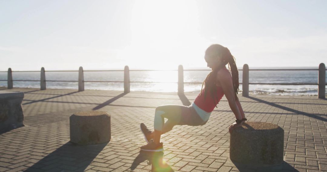 Woman Doing Triceps Dips on Seaside Promenade Backlit at Sunrise Outdoor Fitness