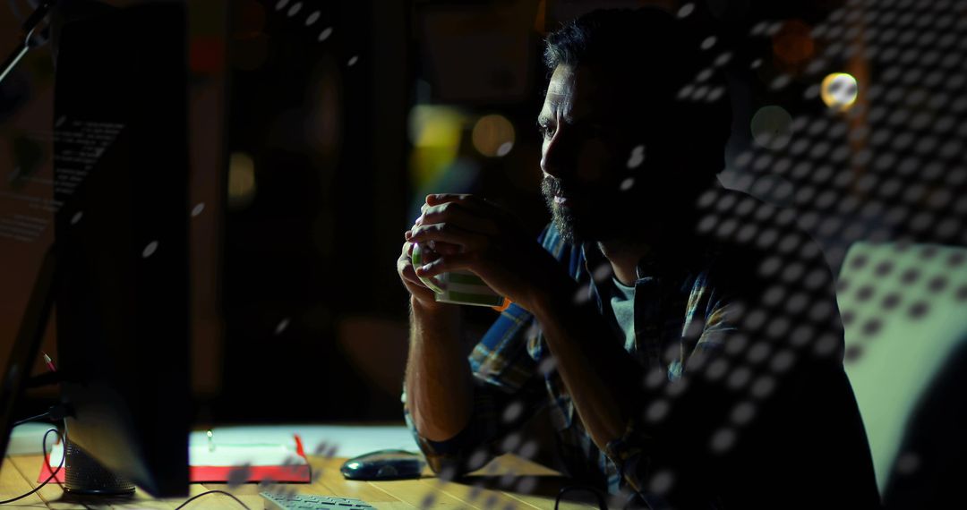 Bearded Man Holding Mug While Working Late at Office Desk