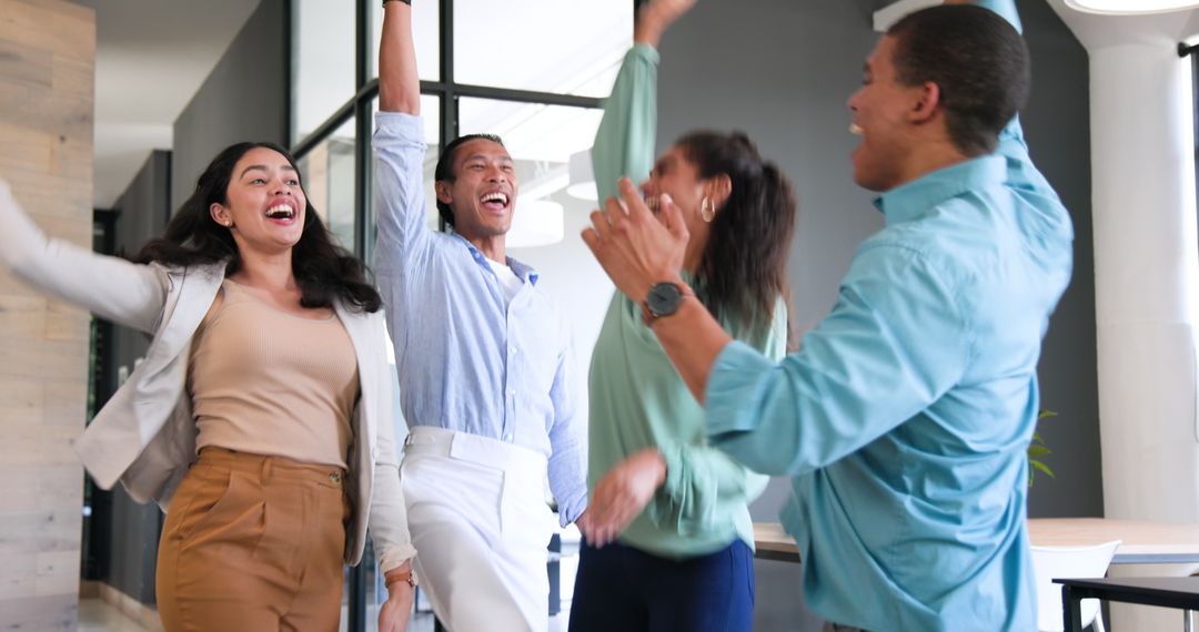 Cheerful Diverse Team Celebrating in Office Environment