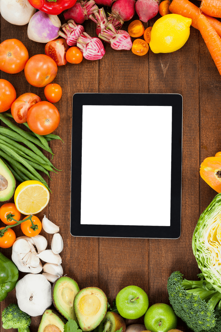 Transparent Tablet Surrounded by Fresh Colorful Vegetables and Fruits