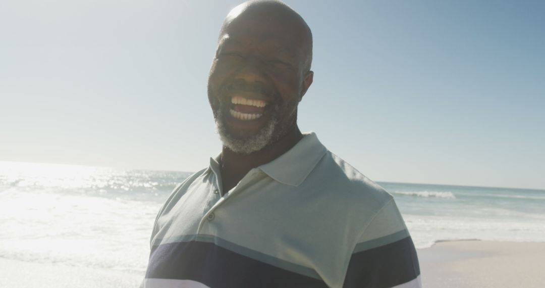 Happy Man Smiling by Beach on Sunny Day - Free Images, Stock Photos and Pictures on Pikwizard.com