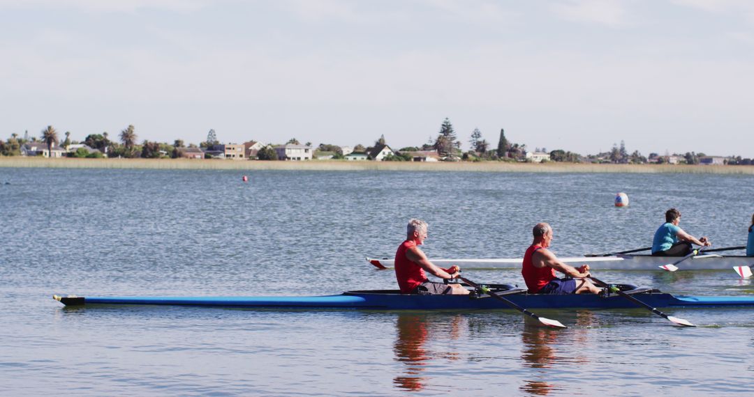 Senior Men Rowing on Serene Lake with Blue Sky - Free Images, Stock Photos and Pictures on Pikwizard.com