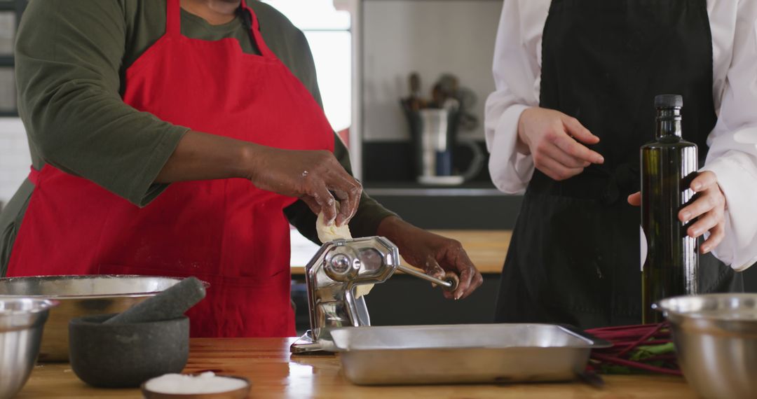 Close-Up of People Preparing Pasta Dough With Machine - Free Images, Stock Photos and Pictures on Pikwizard.com