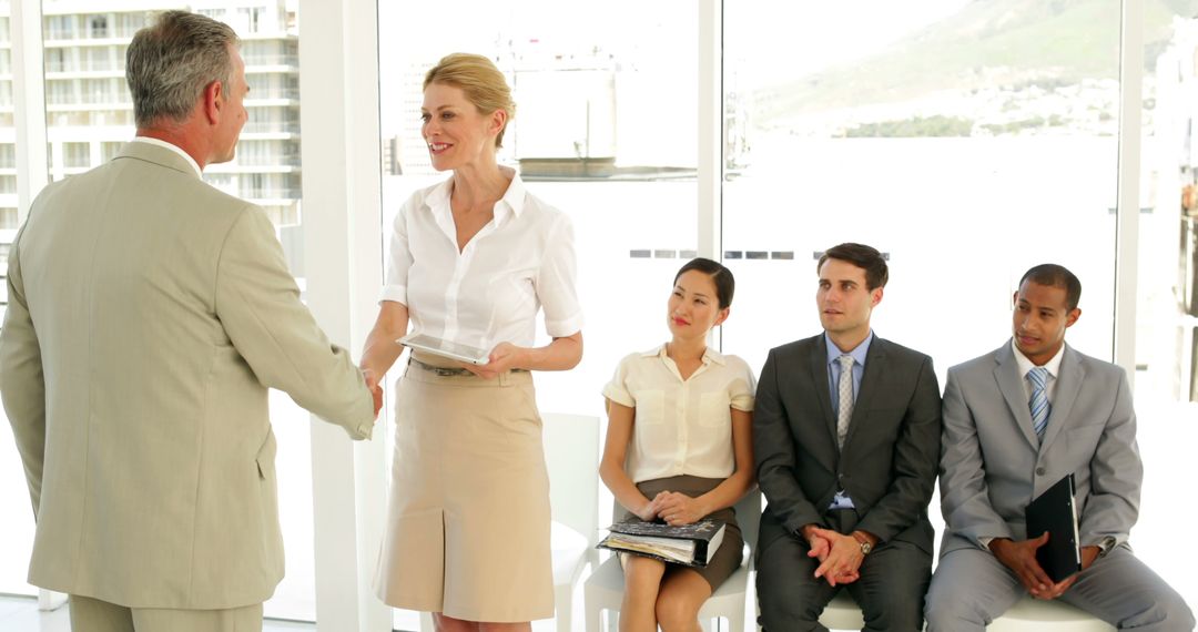Businessman Greeting Job Applicant in Office Interview Setting