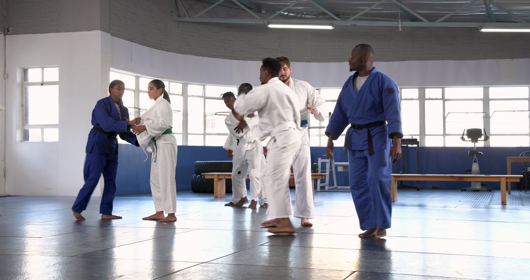 Judo Class in Progress: Practicing Throws and Techniques in Dojo