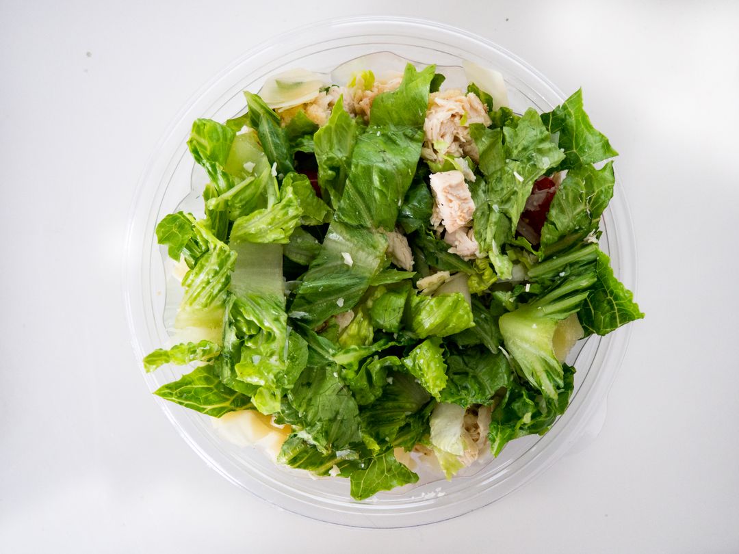Featuring Fresh Chicken Caesar Salad in Clear Plastic Bowl Overhead View for Healthy Lunch