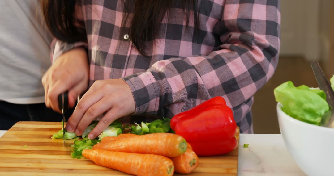 Close-Up of People Chopping Vegetables in Kitchen - Free Images, Stock Photos and Pictures on Pikwizard.com