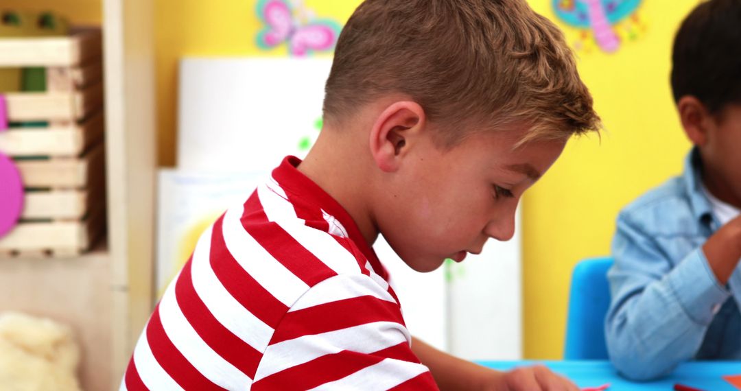 Young Boy Focused on Drawing in Classroom - Free Images, Stock Photos and Pictures on Pikwizard.com