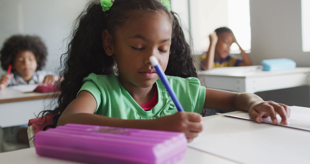 Image of focused african american girl doing lessons in classroom - Free Images, Stock Photos and Pictures on Pikwizard.com
