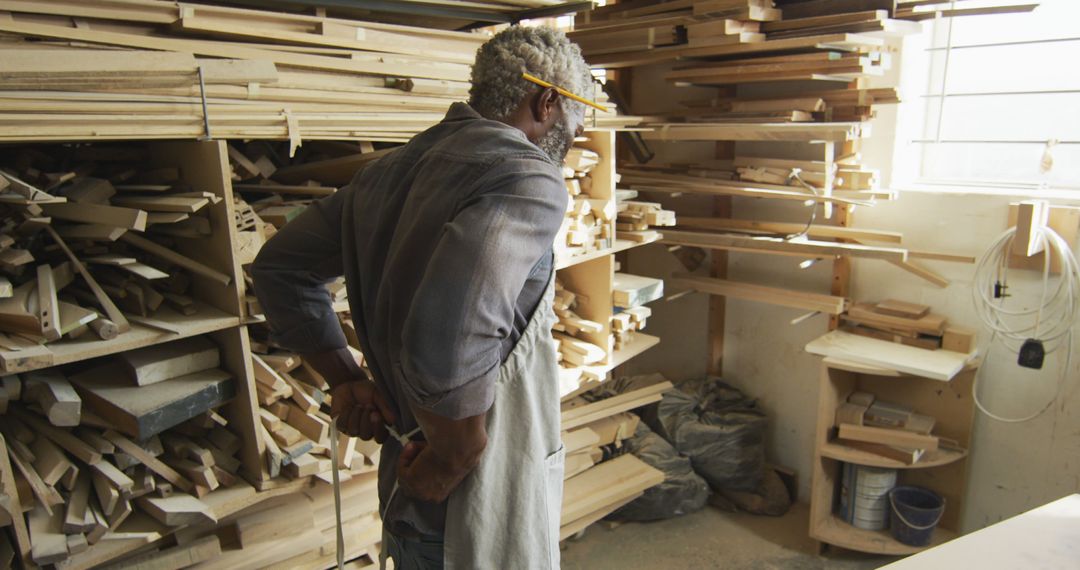 Carpenter Organizing Wooden Planks in Workshop - Free Images, Stock Photos and Pictures on Pikwizard.com