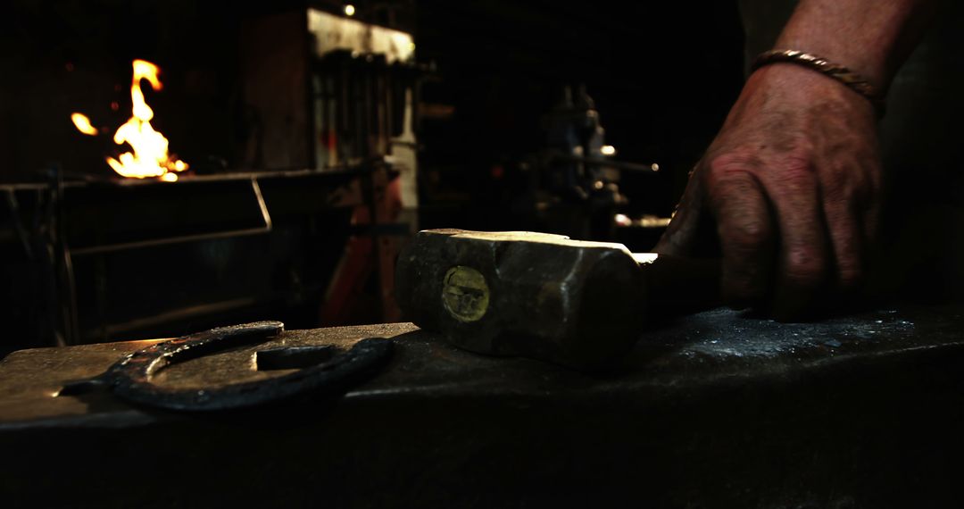 Blacksmith Working with Anvil in Dimly Lit Workshop - Free Images, Stock Photos and Pictures on Pikwizard.com