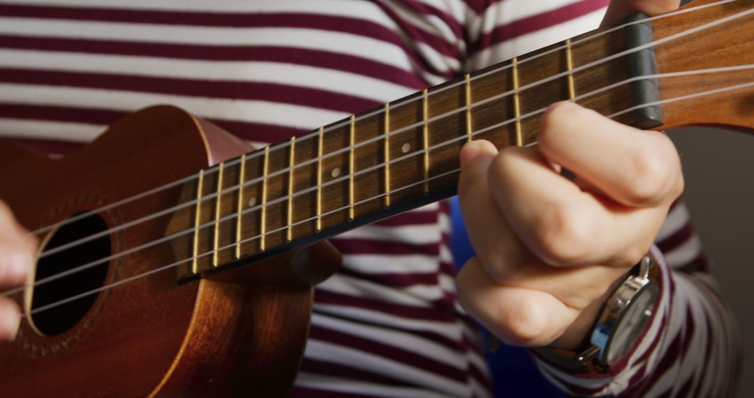 Close-Up of Teenage Girl Playing Ukulele at Home - Free Images, Stock Photos and Pictures on Pikwizard.com