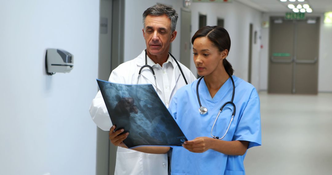 Doctors Reviewing X-ray Images in Hospital Corridor - Free Images, Stock Photos and Pictures on Pikwizard.com