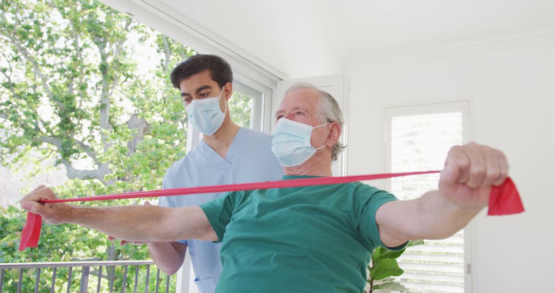 Physical Therapist Assisting Senior Man with Resistance Band Exercises - Free Images, Stock Photos and Pictures on Pikwizard.com