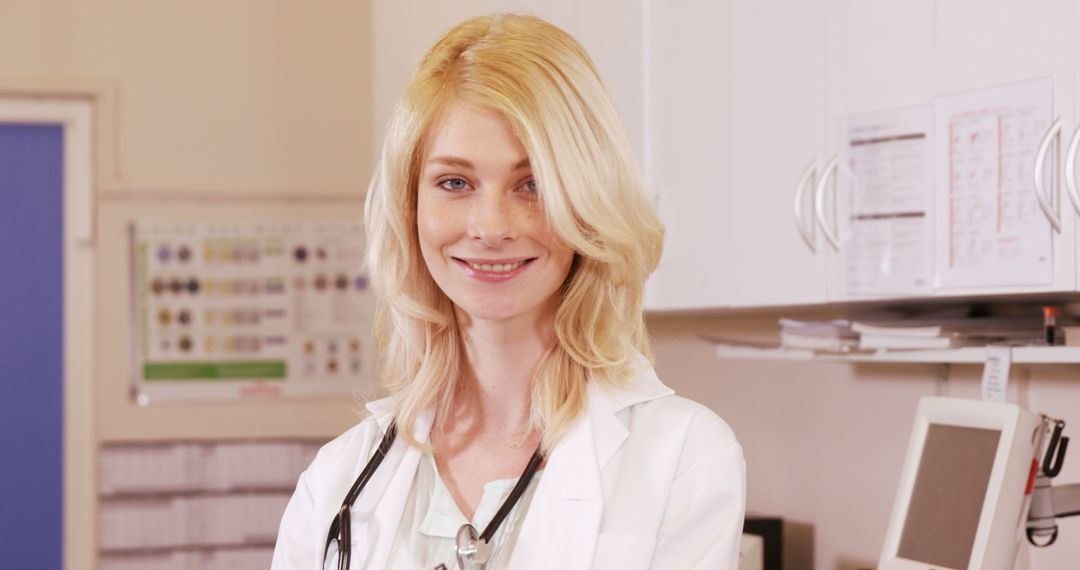 Smiling blonde female doctor in white coat inside hospital office - Free Images, Stock Photos and Pictures on Pikwizard.com