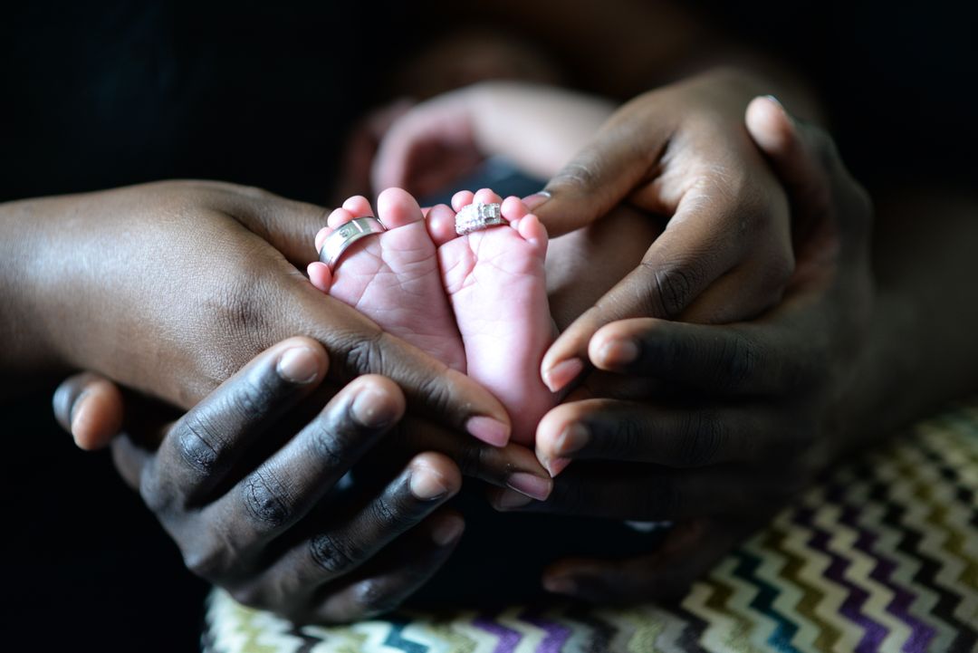 Parents Holding Newborn Baby Feet with Rings - Free Images, Stock Photos and Pictures on Pikwizard.com