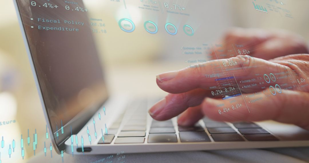 Businessman Analyzing Financial Data on Laptop with Graphs Overlay