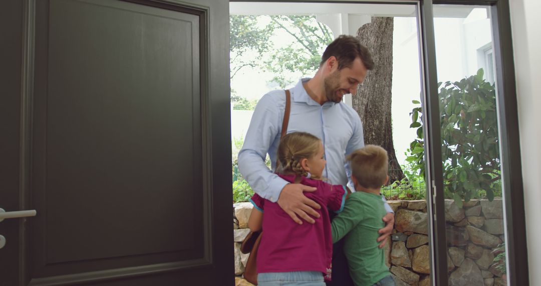 Father Returning Home Embracing Happy Children at Front Door - Free Images, Stock Photos and Pictures on Pikwizard.com