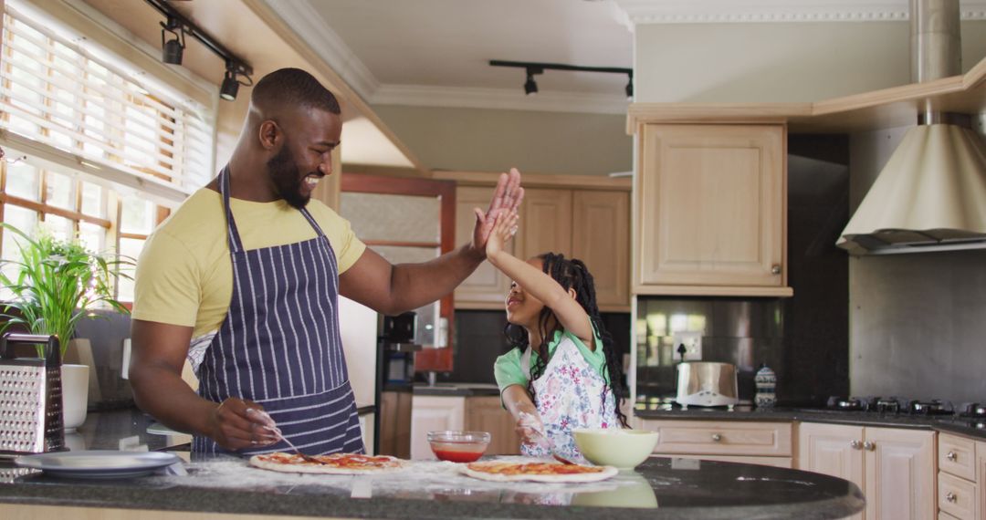 Father and Daughter Bonding While Making Pizza at Home