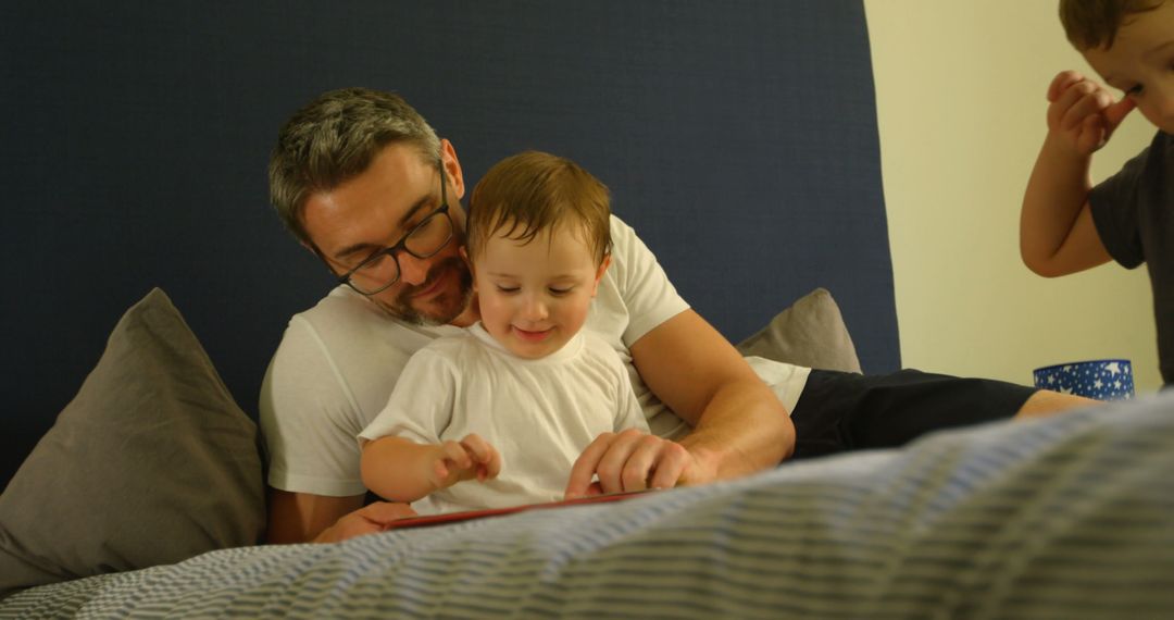 Father Reading Bedtime Story to His Sons - Free Images, Stock Photos and Pictures on Pikwizard.com