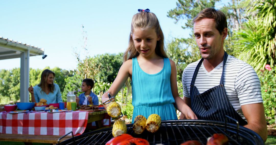 Father and Daughter Grilling Vegetables at Family Barbecue - Free Images, Stock Photos and Pictures on Pikwizard.com